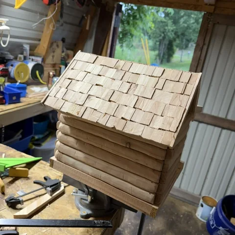 Close on a hand-cut shingle roof, each shake laid separately