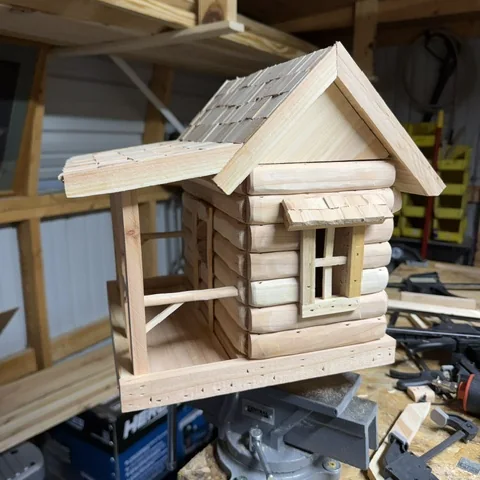 The cabin birdhouse with its window and gable finished