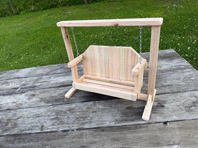 Cedar porch swing with a matching A-frame stand.