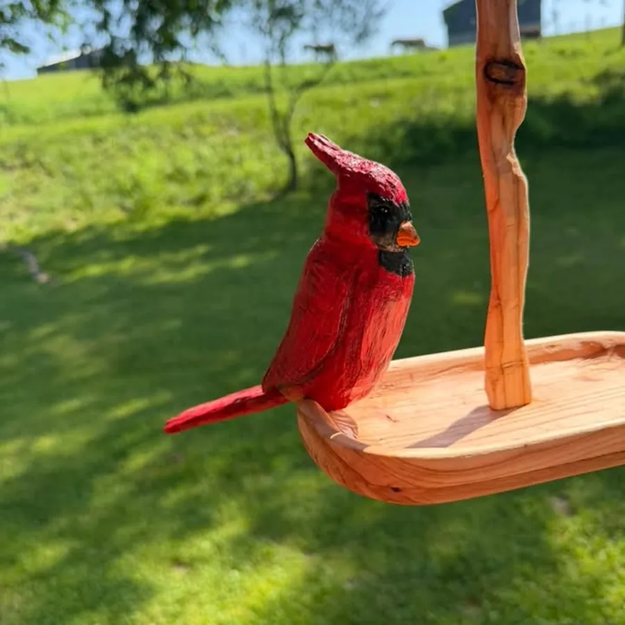 Hand-carved red cardinal painted by hand, mounted on a live-edge wooden perch