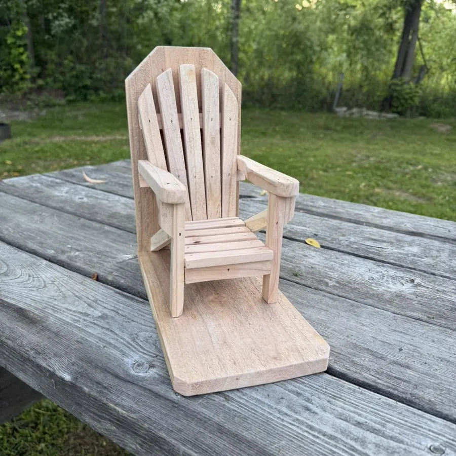 Handmade cedar Adirondack chair squirrel feeder with fanned back slats, mounted on its own deck base