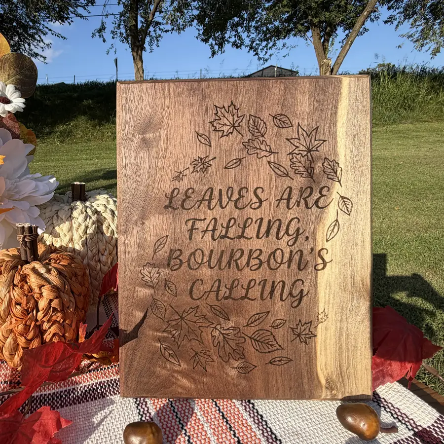 Solid black walnut plaque with cursive script and falling leaves burned into the wood