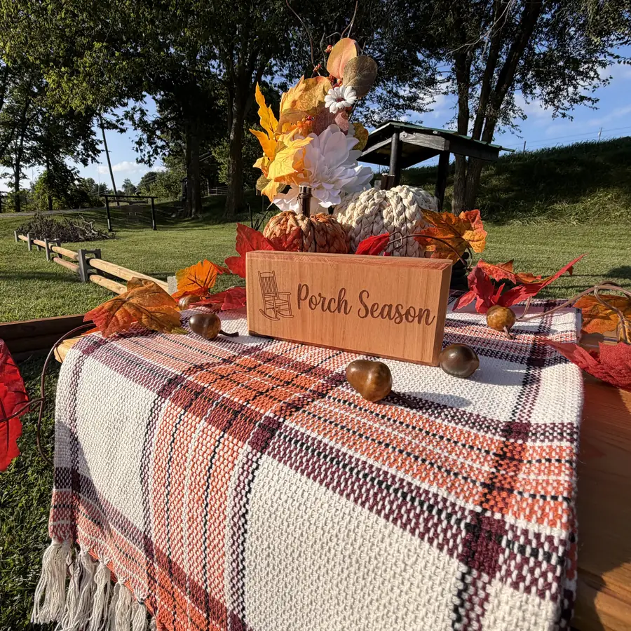 Solid cherry sign block with a rocking chair and the words porch season burned into the wood
